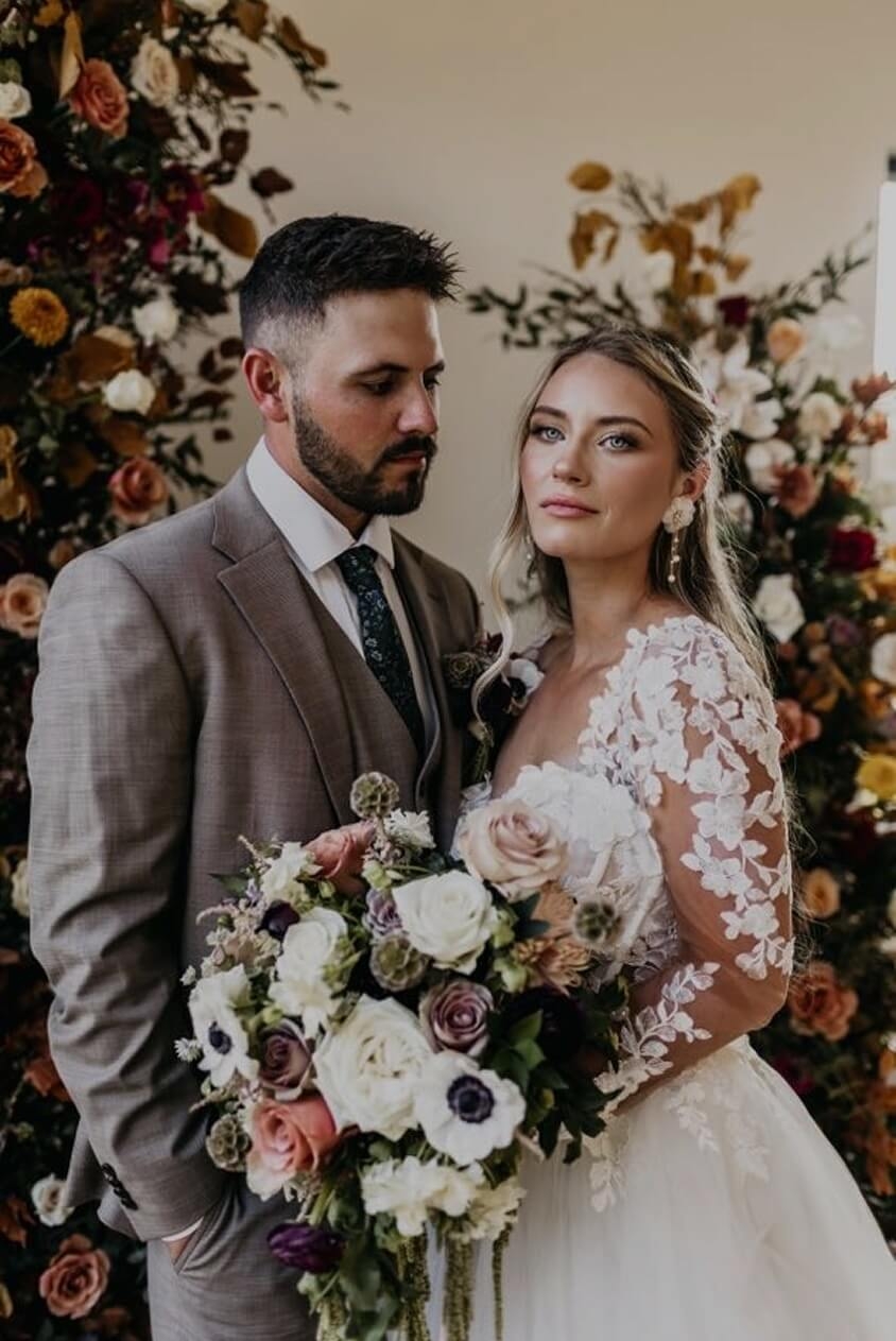 Сouple wearing a white gown and a gray suit
